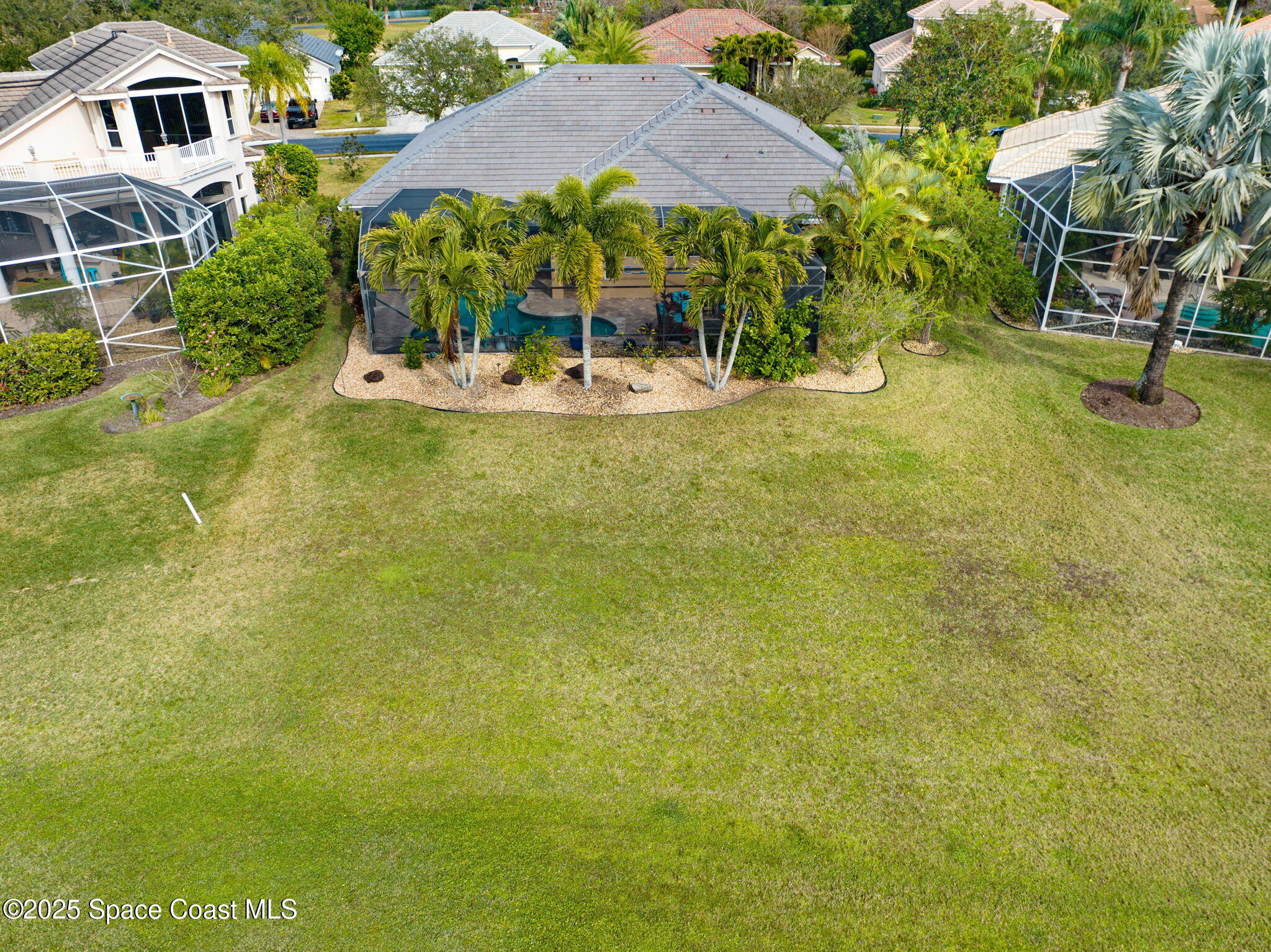 8082 Old Tramway Drive Melbourne, FL 32940 - Photo 68 of 82 a view of a swimming pool with a lawn chairs under an umbrella