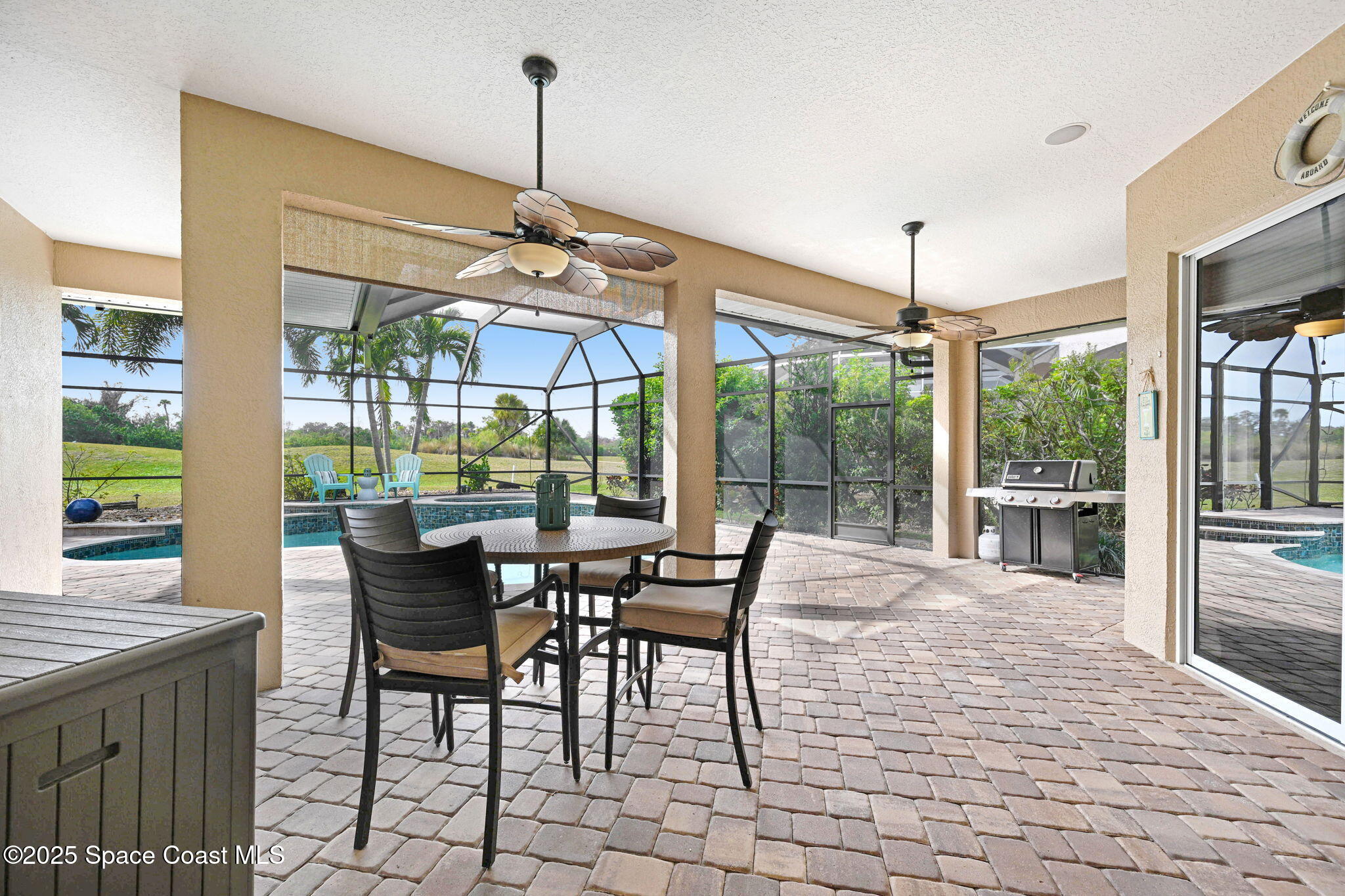 8082 Old Tramway Drive Melbourne, FL 32940 - Photo 7 of 82 a dining room with furniture large windows and a chandelier