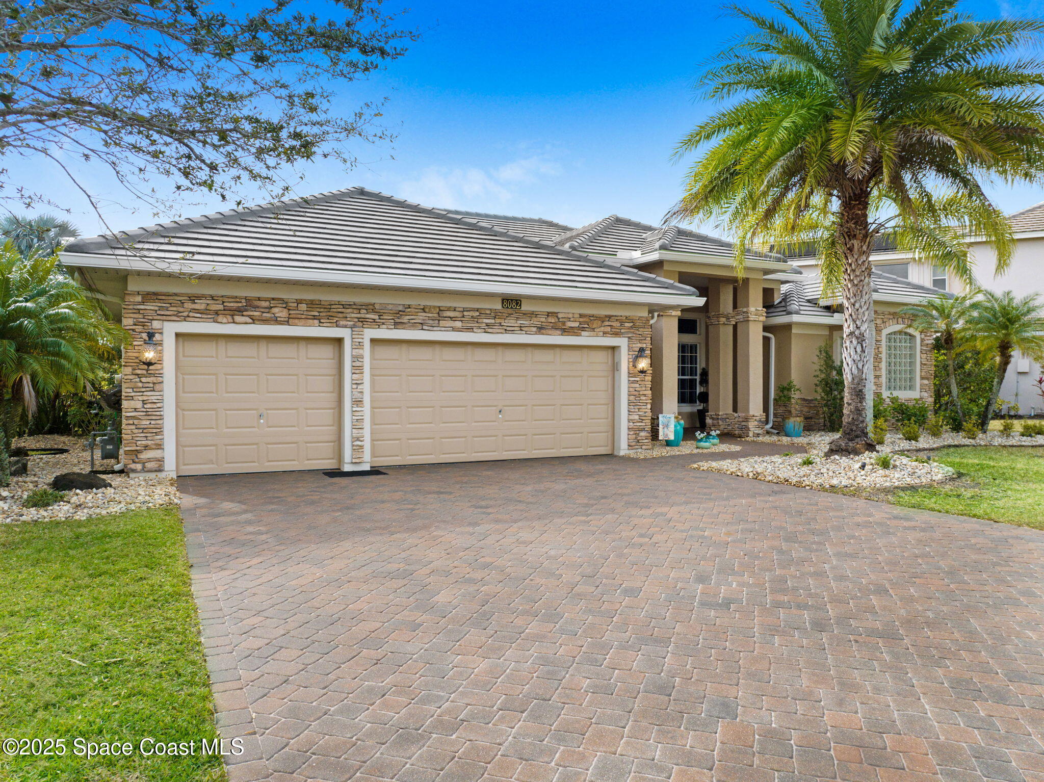 8082 Old Tramway Drive Melbourne, FL 32940 - Photo 71 of 82 a front view of a house with a yard and garage