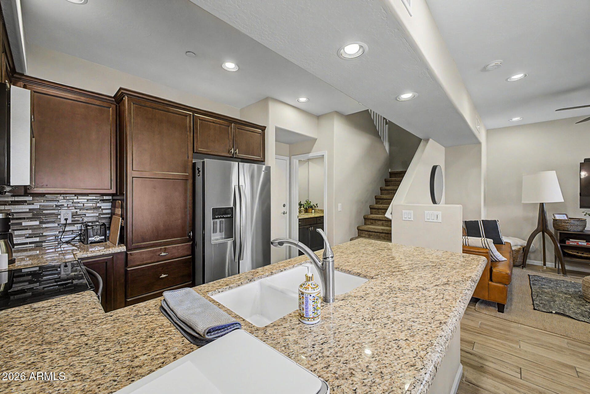 3935 East Rough Rider Road, Unit 1373 Phoenix, AZ 85050 - Photo 11 of 48 a kitchen with stainless steel appliances kitchen island granite countertop a refrigerator and stove