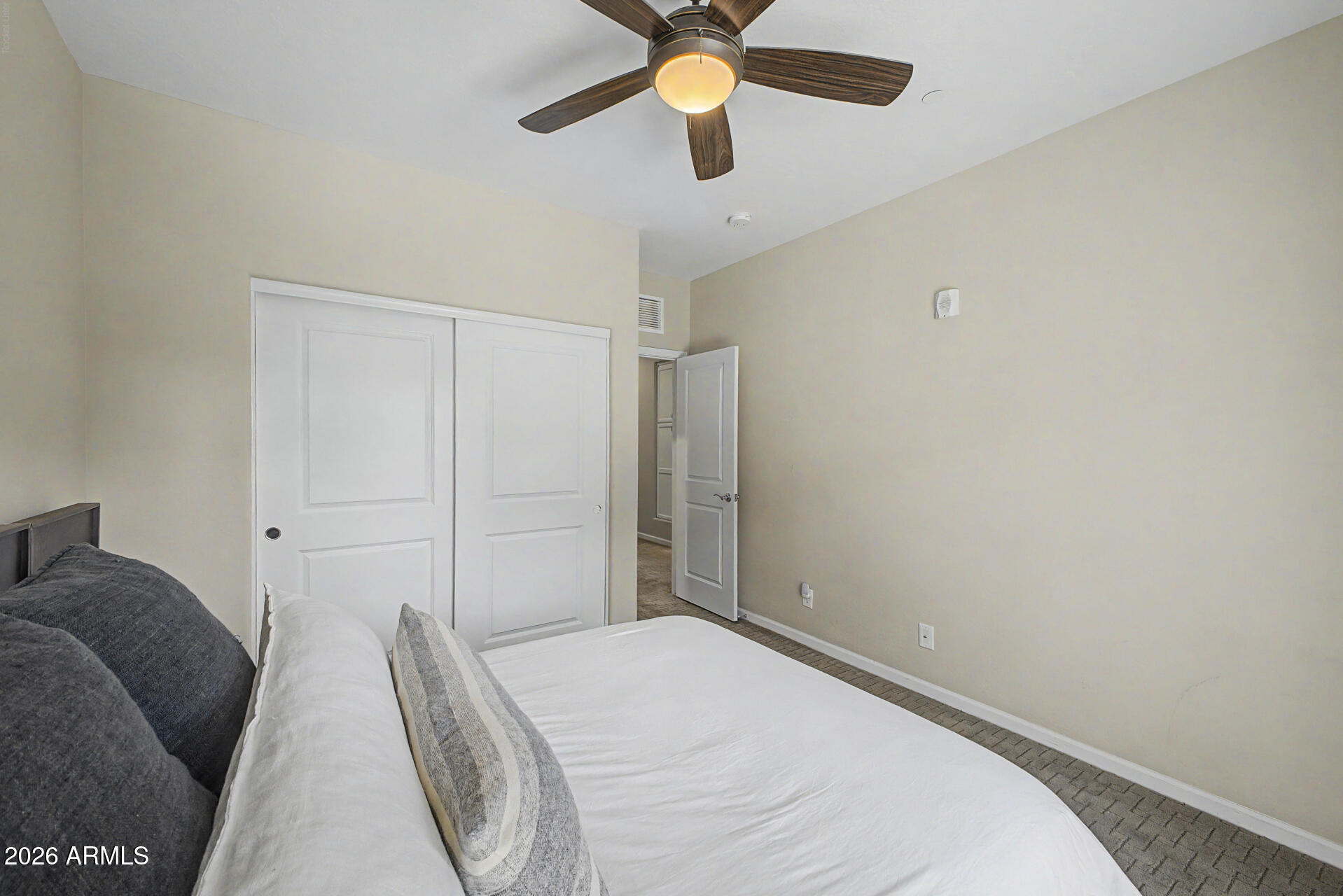 3935 East Rough Rider Road, Unit 1373 Phoenix, AZ 85050 - Photo 22 of 48 a bedroom with a bed and a ceiling fan