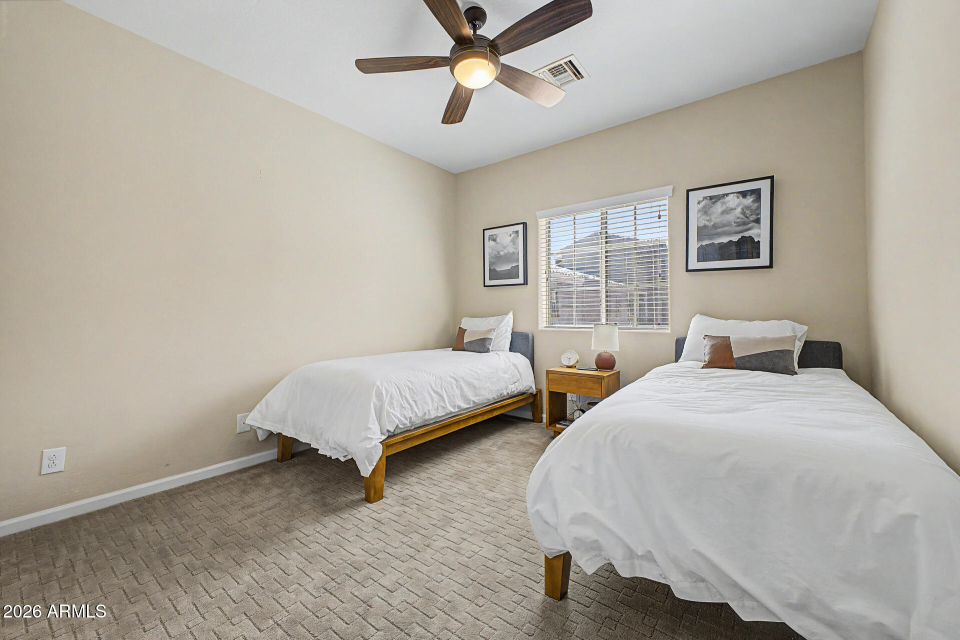 3935 East Rough Rider Road, Unit 1373 Phoenix, AZ 85050 - Photo 24 of 48 a bedroom with two beds and painting on the wall
