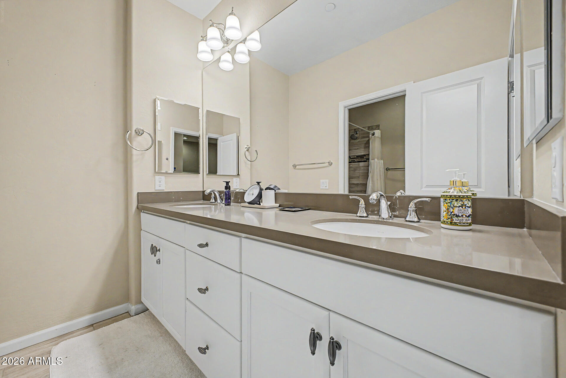 3935 East Rough Rider Road, Unit 1373 Phoenix, AZ 85050 - Photo 25 of 48 a bathroom with a double vanity sink and a mirror