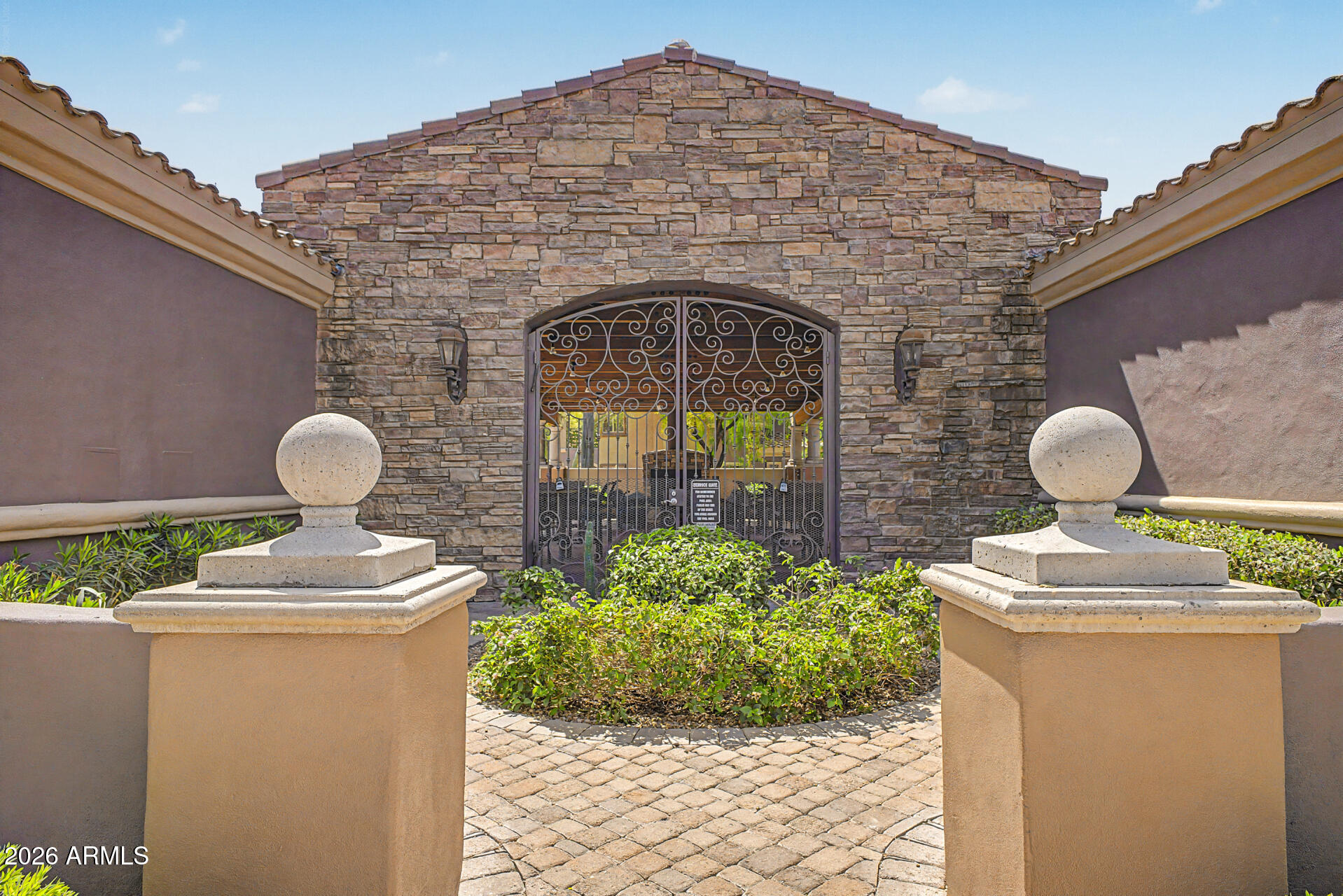 3935 East Rough Rider Road, Unit 1373 Phoenix, AZ 85050 - Photo 33 of 48 a front view of a house with garden
