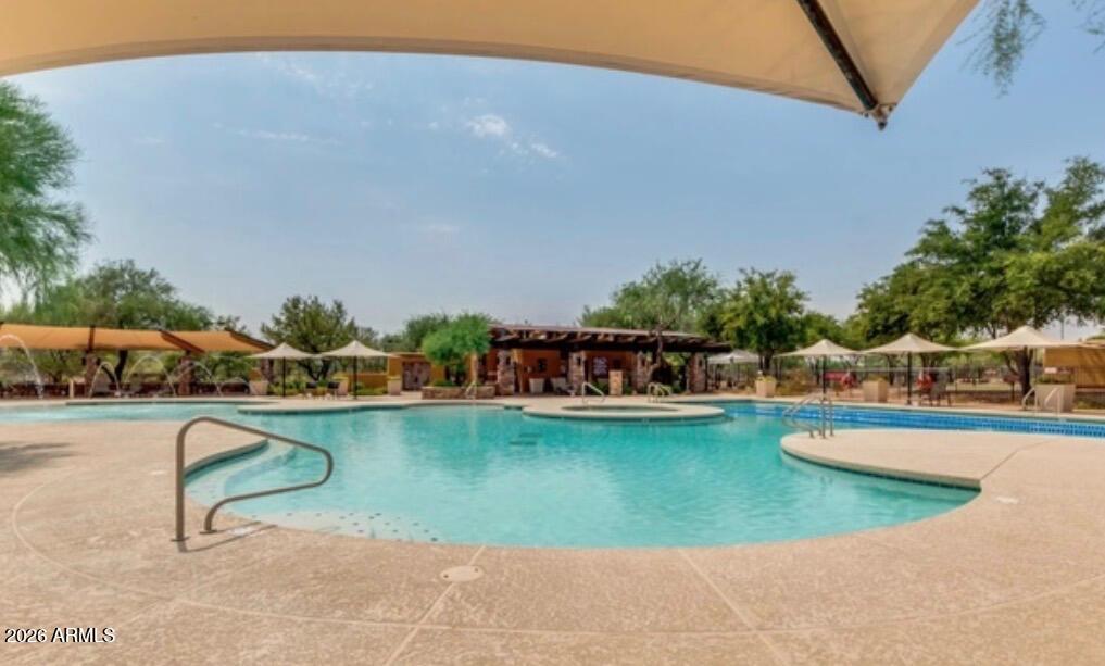 3935 East Rough Rider Road, Unit 1373 Phoenix, AZ 85050 - Photo 47 of 48 a view of a swimming pool with a table and chairs