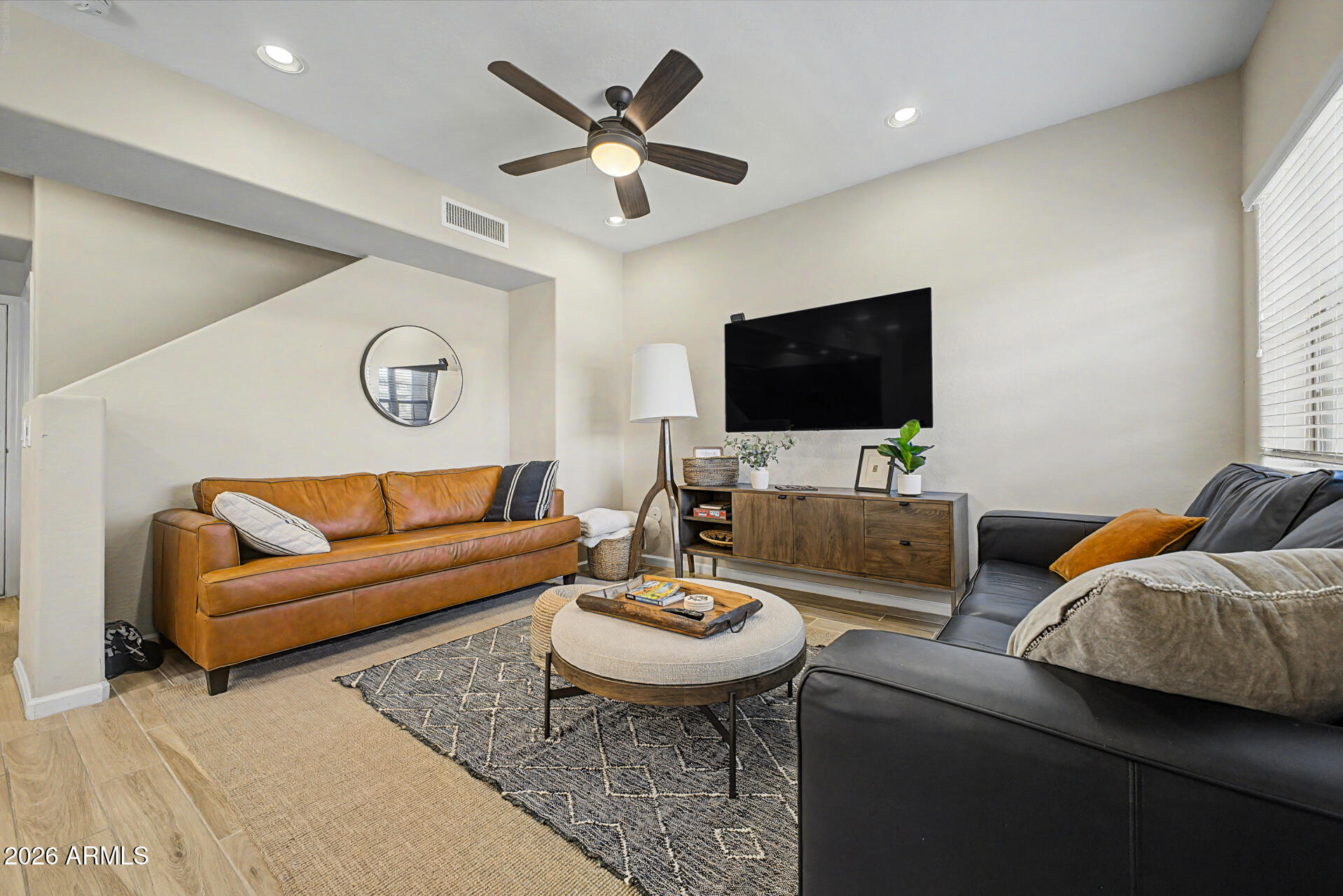 3935 East Rough Rider Road, Unit 1373 Phoenix, AZ 85050 - Photo 6 of 48 a living room with furniture and a flat screen tv