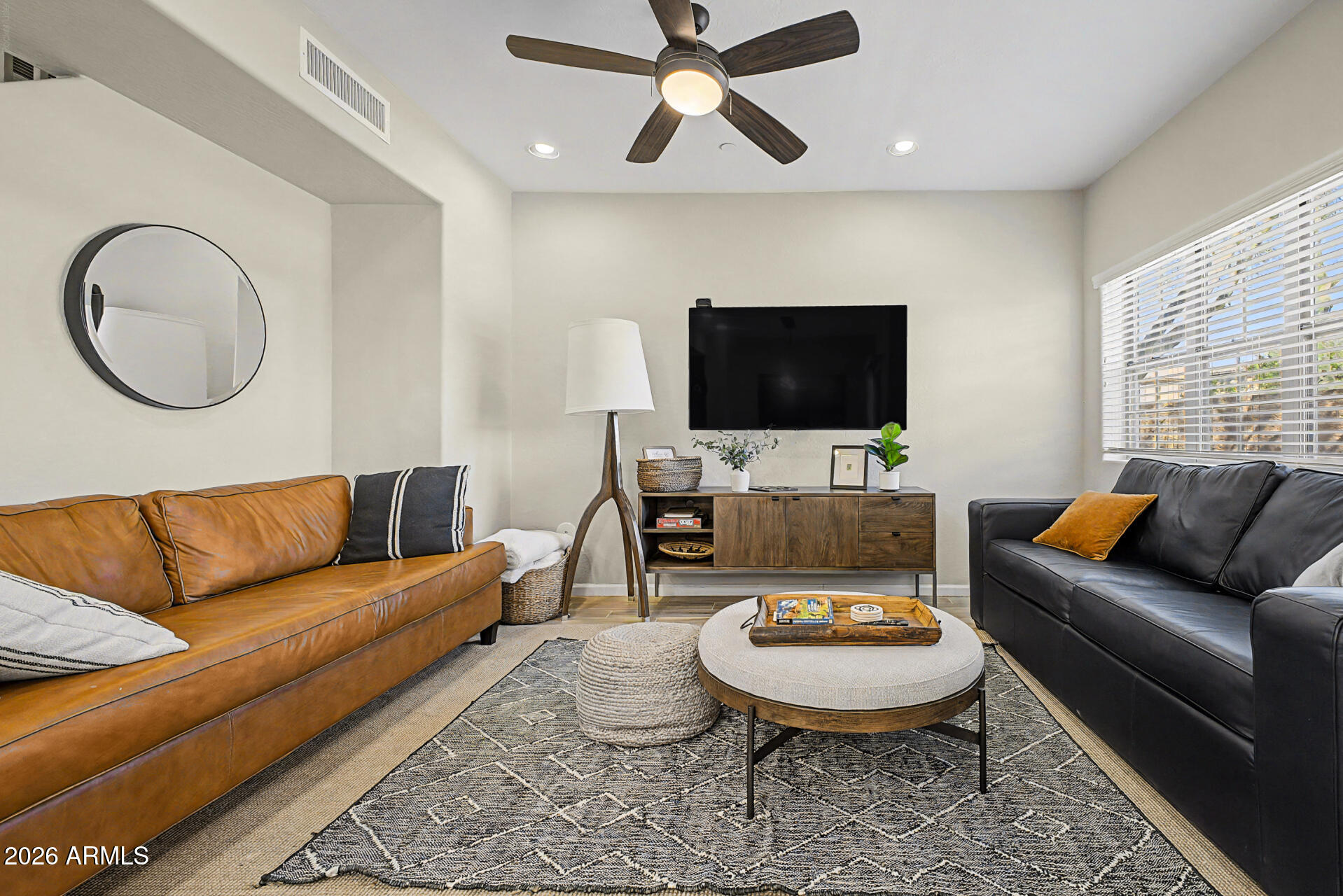 3935 East Rough Rider Road, Unit 1373 Phoenix, AZ 85050 - Photo 7 of 48 a living room with furniture a rug and a flat screen tv