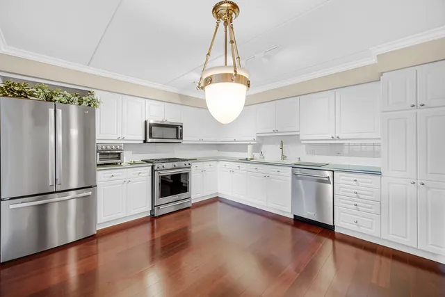 a kitchen with white cabinets and white appliances