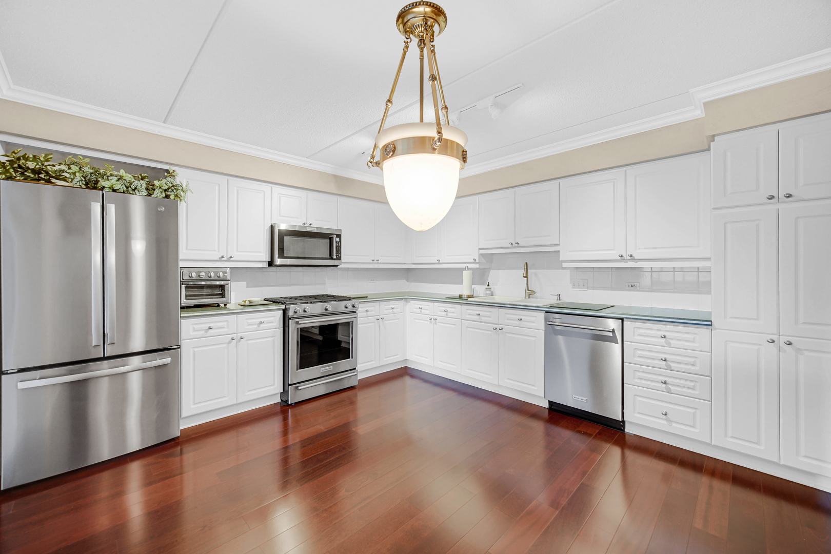 730 Creekside Drive, Unit 405C Mount Prospect, IL 60056 - Photo 5 of 34 a kitchen with white cabinets stainless steel appliances and wooden floor