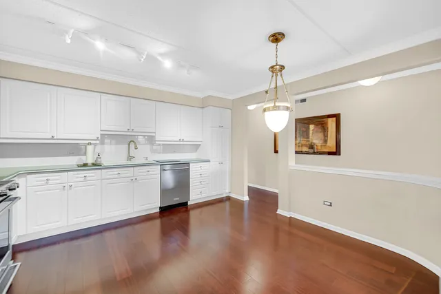 a view of a big room with wooden floor and windows