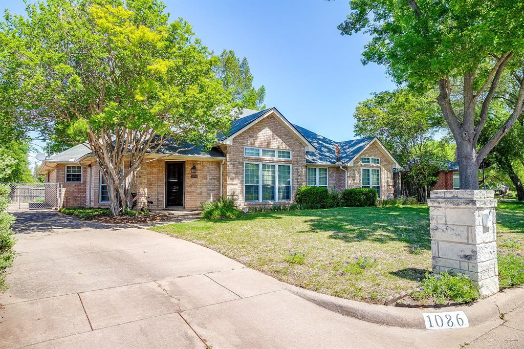 1086 Rock Ridge Drive Burleson, TX 76028 - Photo 1 of 40 a front view of a house with a yard
