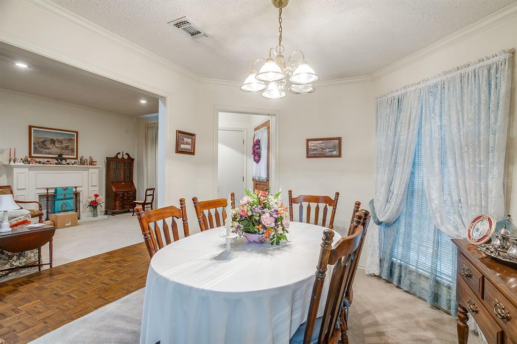 1086 Rock Ridge Drive Burleson, TX 76028 - Photo 11 of 40 a view of a dining room with furniture and chandelier