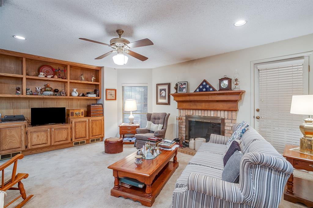 1086 Rock Ridge Drive Burleson, TX 76028 - Photo 16 of 40 a living room with furniture a fireplace and a flat screen tv