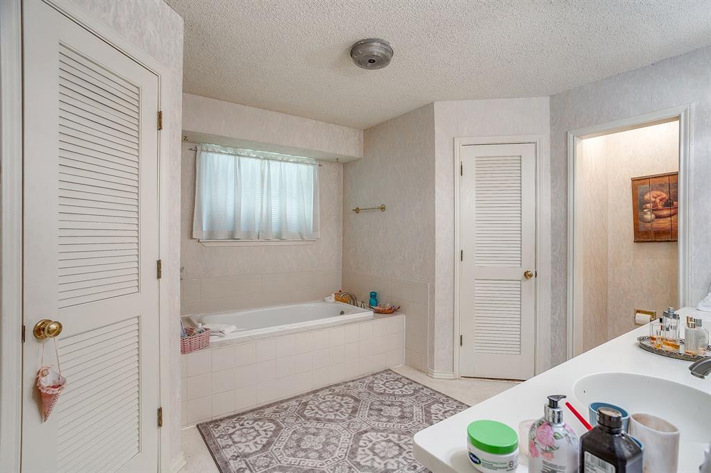 1086 Rock Ridge Drive Burleson, TX 76028 - Photo 24 of 40 a bathroom with a sink and a bath tub