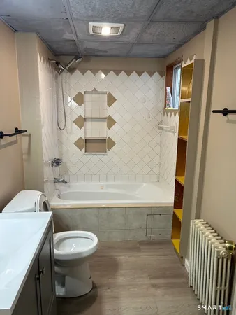 a bathroom with a toilet and a shower