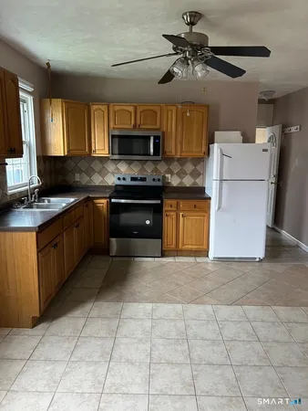 a kitchen with stainless steel appliances granite countertop a stove sink and cabinets
