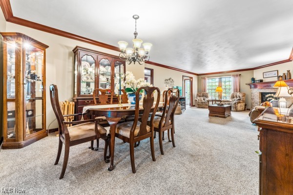 197 Mathews Road, Unit A Youngstown, OH 44512 - Photo 3 of 32 Carpeted dining area with a fireplace, ornamental molding, and a chandelier