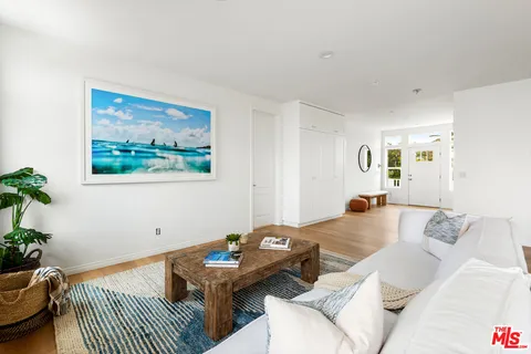 a living room with furniture a couch and a potted plant
