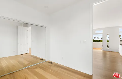 a view of a room with wooden floor