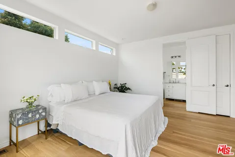 a bedroom with a bed and hallway