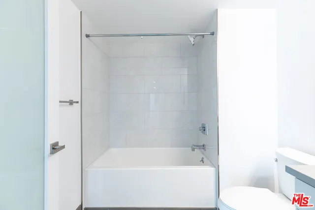 a bathroom with a bathtub and a toilet