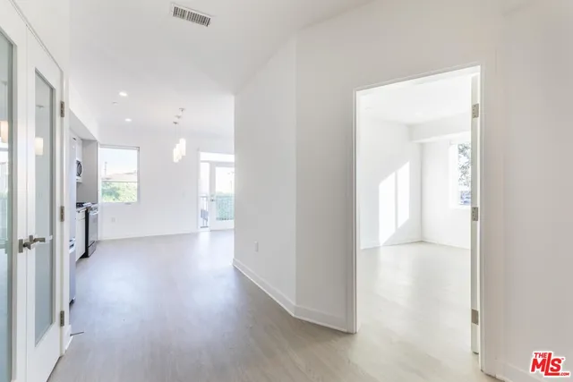 a view of a hallway with wooden floor