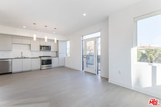 a view of a kitchen with electric equipment and windows