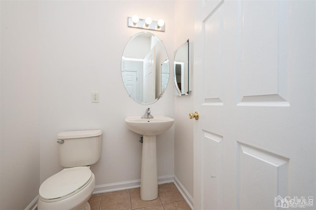 368 Rector Street, Unit 514 Perth Amboy, NJ 08861 - Photo 21 of 24 a bathroom with a toilet sink and mirror