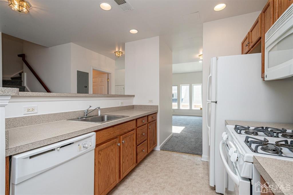 368 Rector Street, Unit 514 Perth Amboy, NJ 08861 - Photo 6 of 24 a kitchen with a sink stove and refrigerator