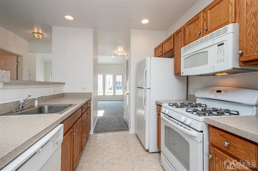 368 Rector Street, Unit 514 Perth Amboy, NJ 08861 - Photo 7 of 24 a kitchen with stainless steel appliances granite countertop a sink stove and refrigerator