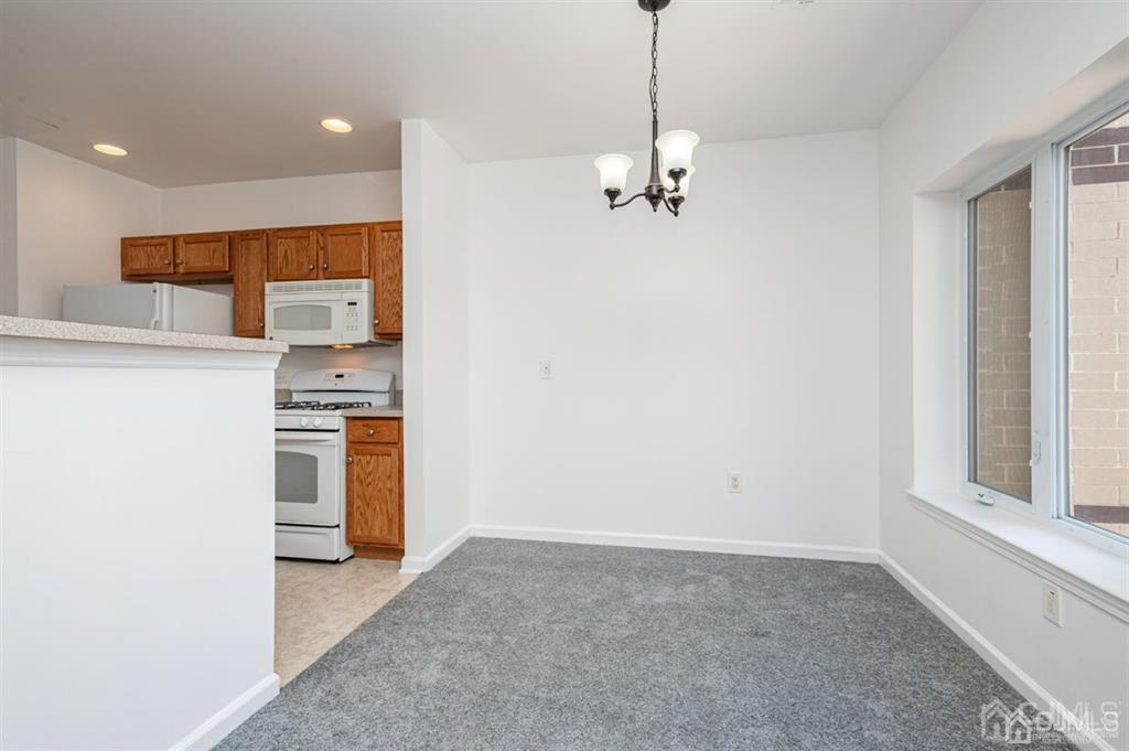 368 Rector Street, Unit 514 Perth Amboy, NJ 08861 - Photo 10 of 24 a view of a kitchen with a sink and a refrigerator