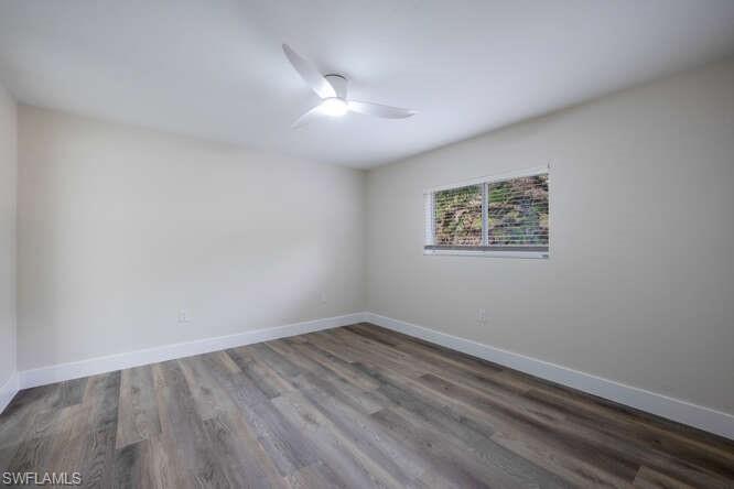 140 Cypress Way East, Unit 601 Naples, FL 34110 - Photo 12 of 27 wooden floor in an empty room