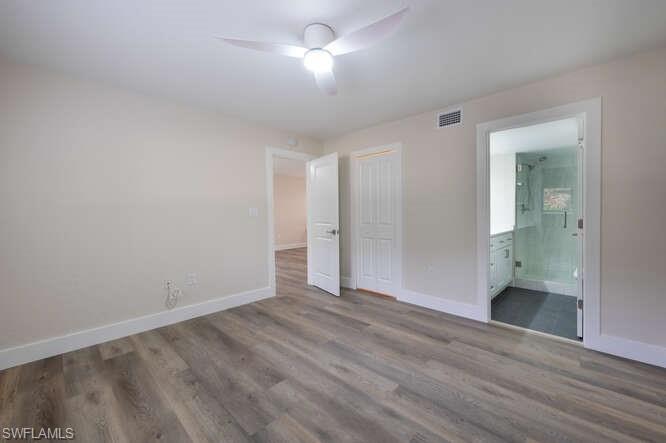 140 Cypress Way East, Unit 601 Naples, FL 34110 - Photo 13 of 27 wooden floor in an empty room