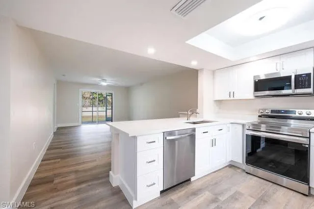 a kitchen with a stove top oven and sink
