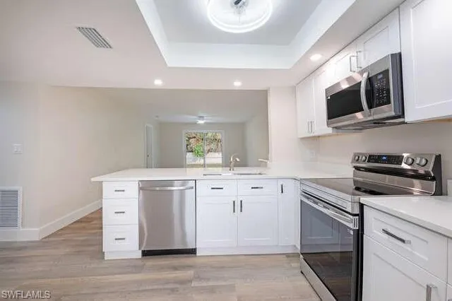 a kitchen with stainless steel appliances a stove microwave and cabinets