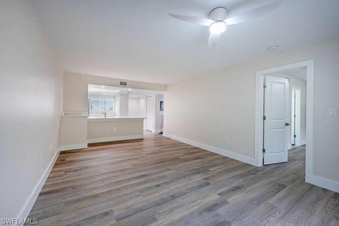 140 Cypress Way East, Unit 601 Naples, FL 34110 - Photo 9 of 27 a view of empty room with wooden floor