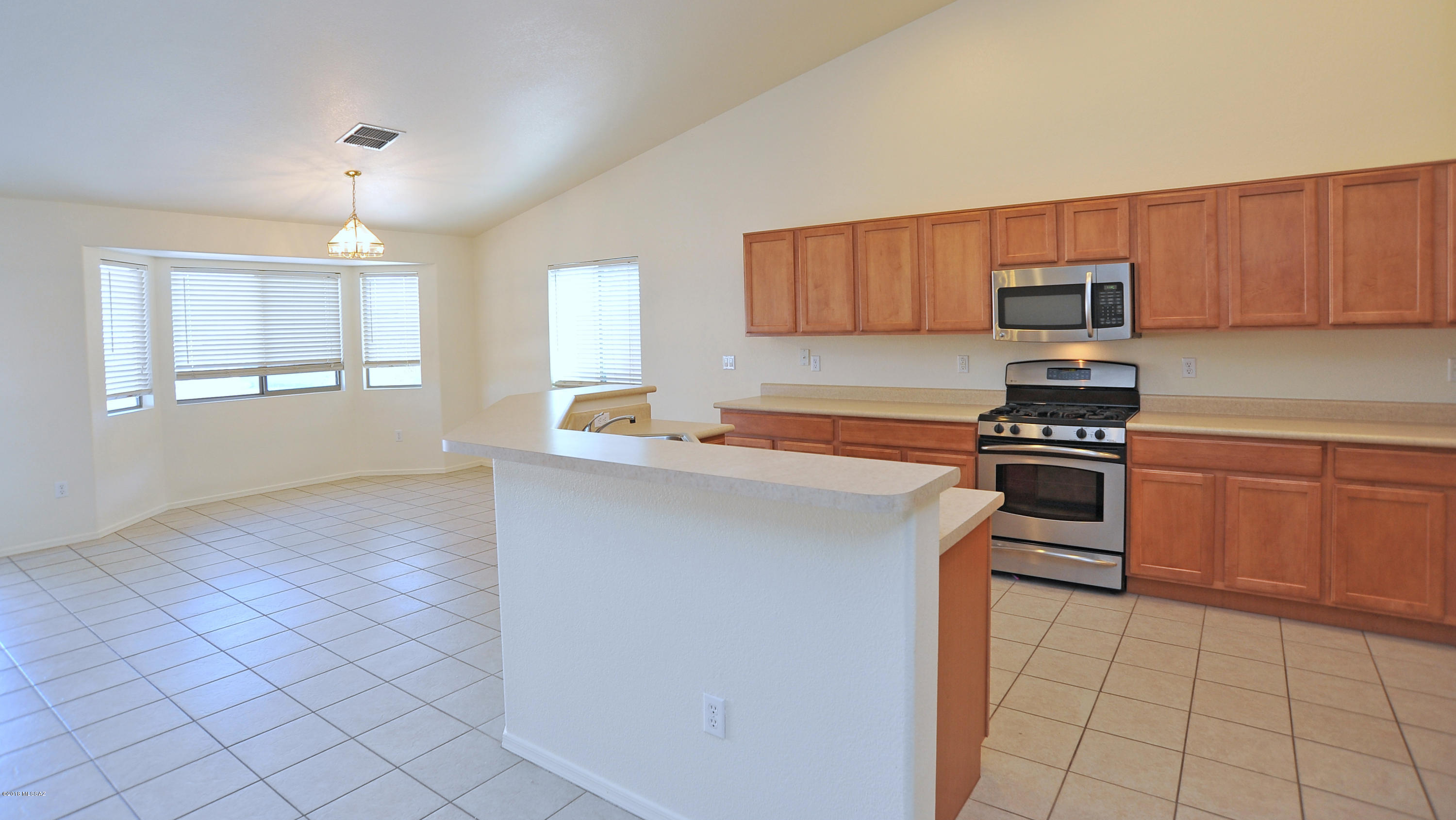 558 West Chatfield Street Vail, AZ 85641 - Photo 6 of 31 a kitchen with a sink a stove and cabinets