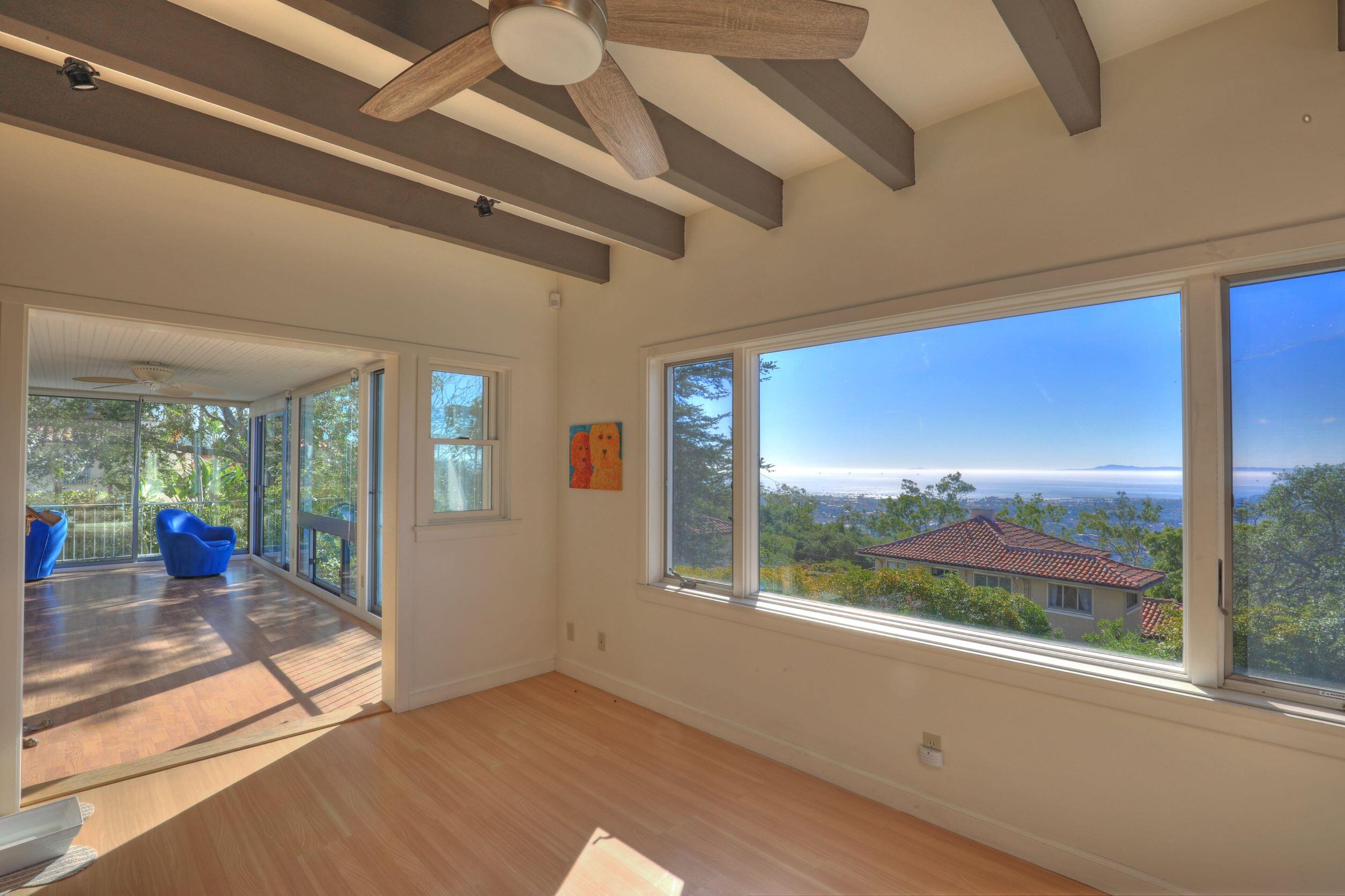 1713 Lasuen Road Santa Barbara, CA 93103 - Photo 11 of 20 a view of an empty room with wooden floor and a large window