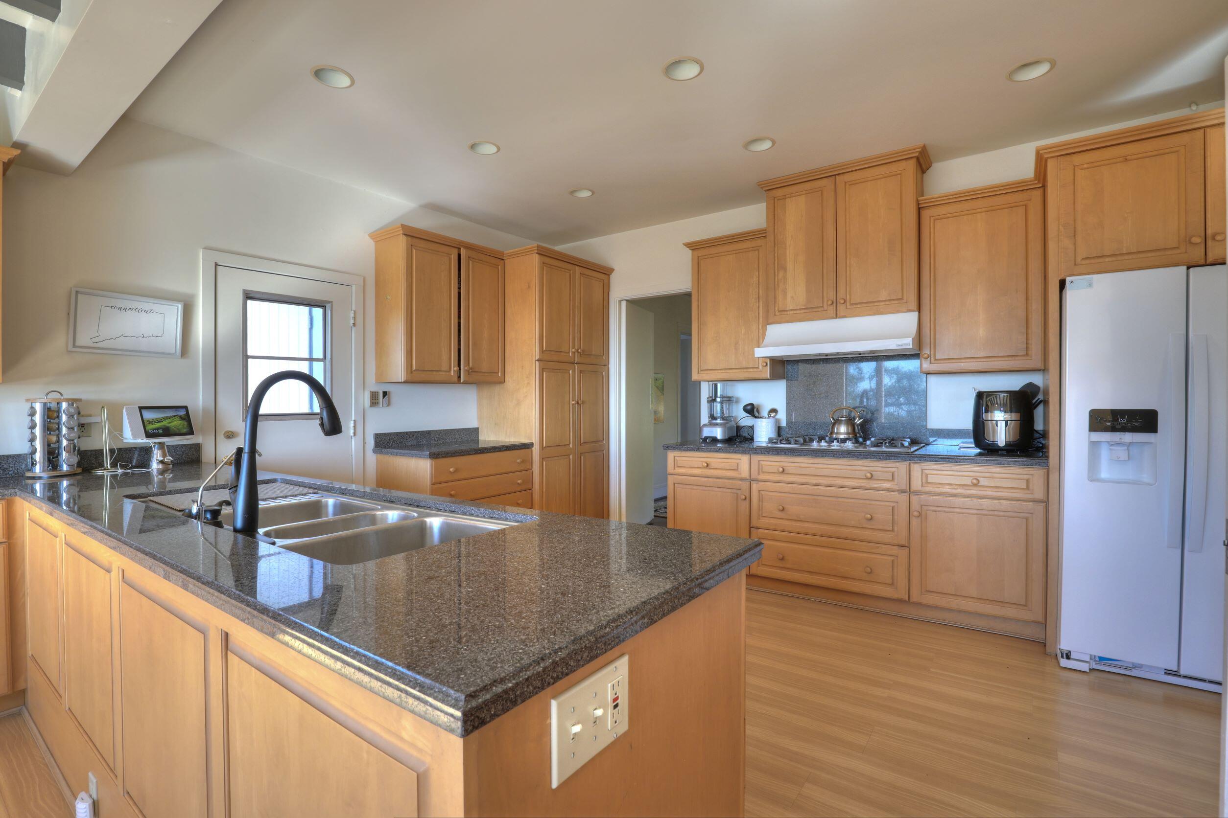1713 Lasuen Road Santa Barbara, CA 93103 - Photo 13 of 20 a kitchen with stainless steel appliances granite countertop a sink a stove and refrigerator