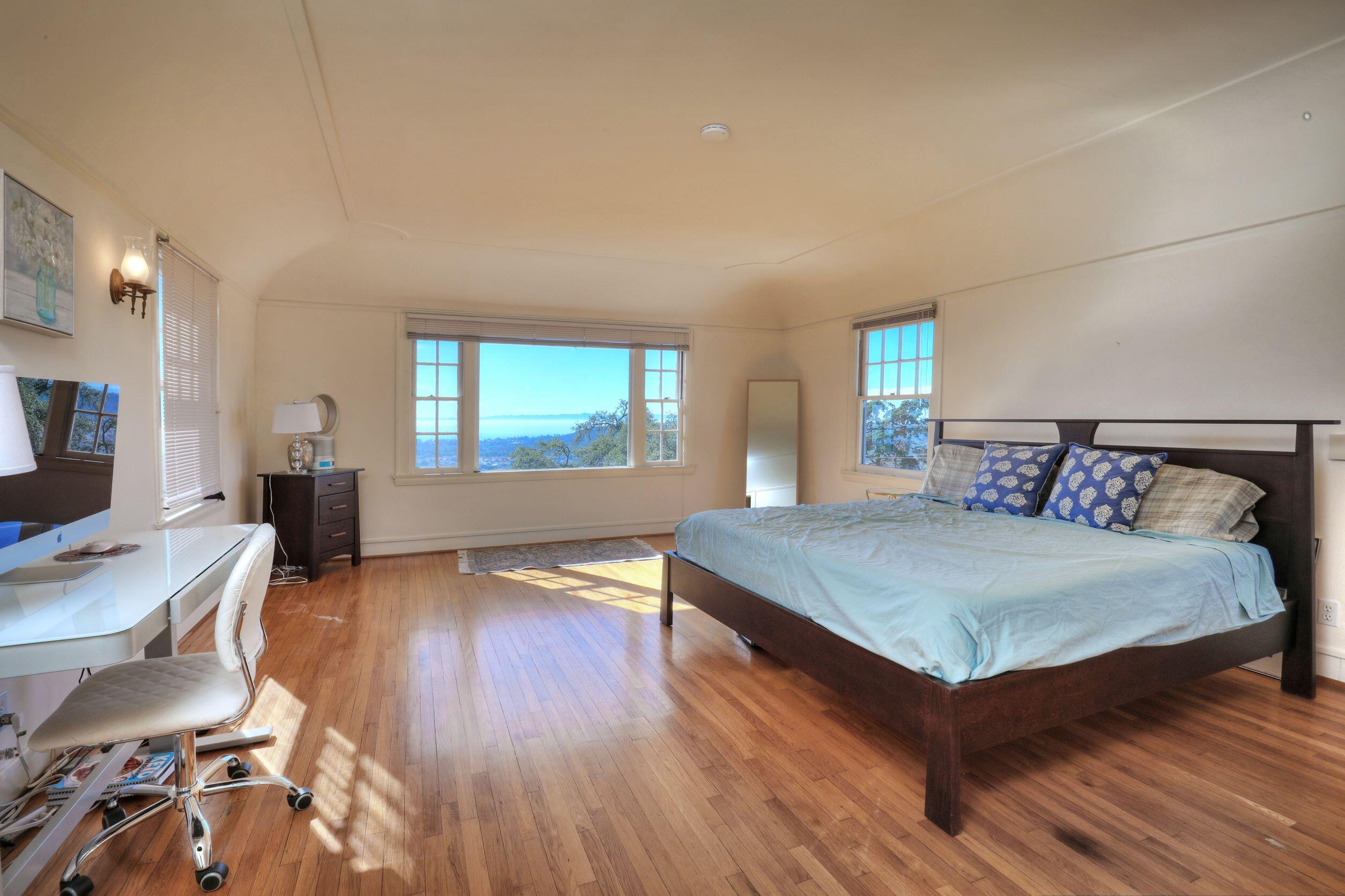 1713 Lasuen Road Santa Barbara, CA 93103 - Photo 14 of 20 a bedroom with a bed and wooden floor