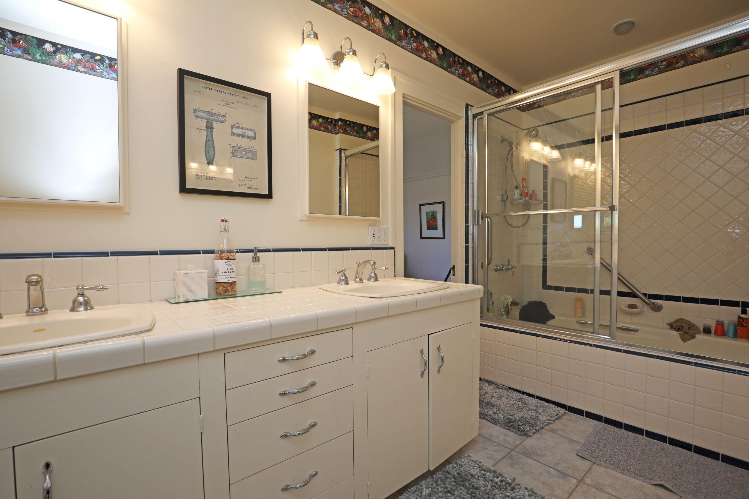 1713 Lasuen Road Santa Barbara, CA 93103 - Photo 17 of 20 a bathroom with a double vanity sink mirror and bathtub