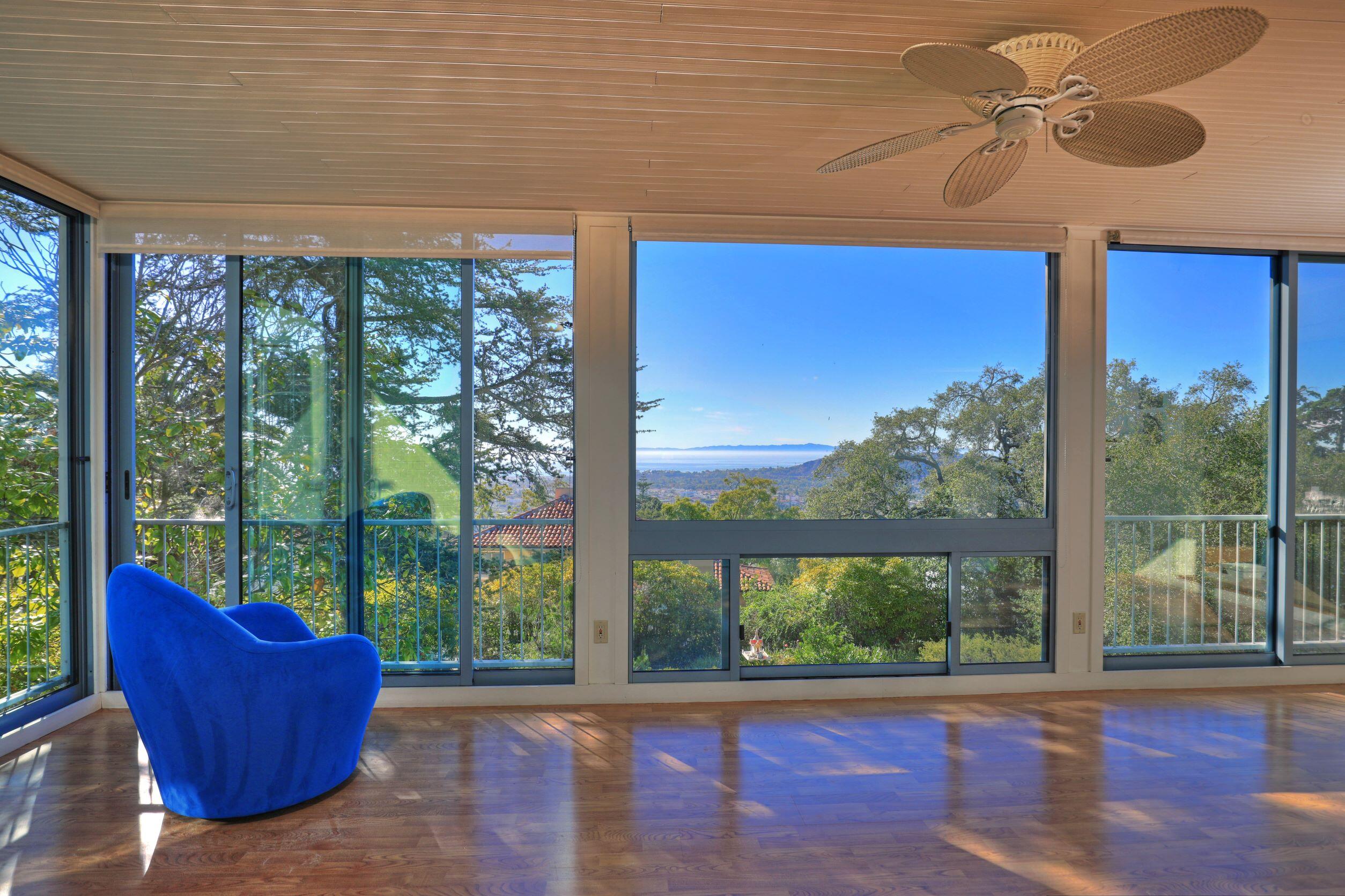 1713 Lasuen Road Santa Barbara, CA 93103 - Photo 7 of 20 a living room with couch floor to ceiling windows and a table