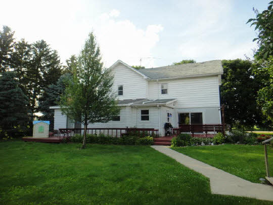 4007 East Lamm Road Freeport, IL 61032 - Photo 5 of 11 a view of house with a big yard and potted plants
