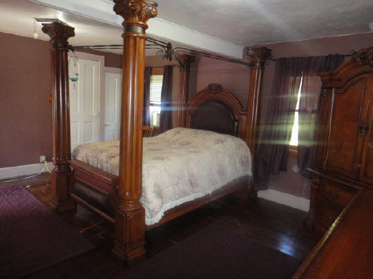 4007 East Lamm Road Freeport, IL 61032 - Photo 10 of 11 a bedroom with a bed and a chandelier