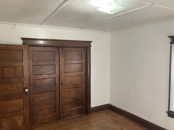 a view of walk in closet with empty racks