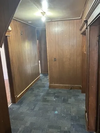 a view of entryway with wooden walls