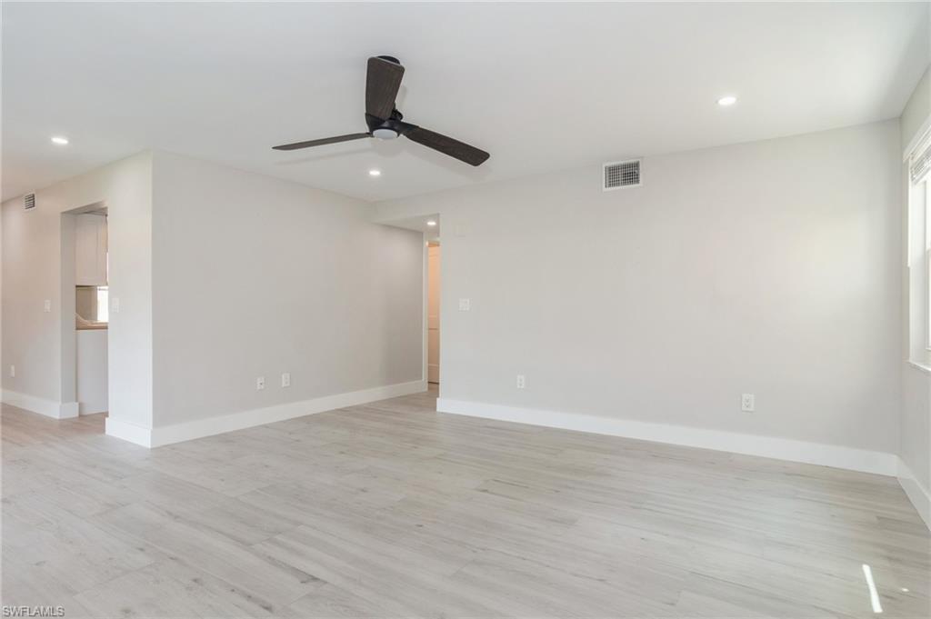 1155 Sandpiper Street, Unit B3 Naples, FL 34102 - Photo 2 of 21 Empty room with a ceiling fan, light wood-style floors, and recessed lighting