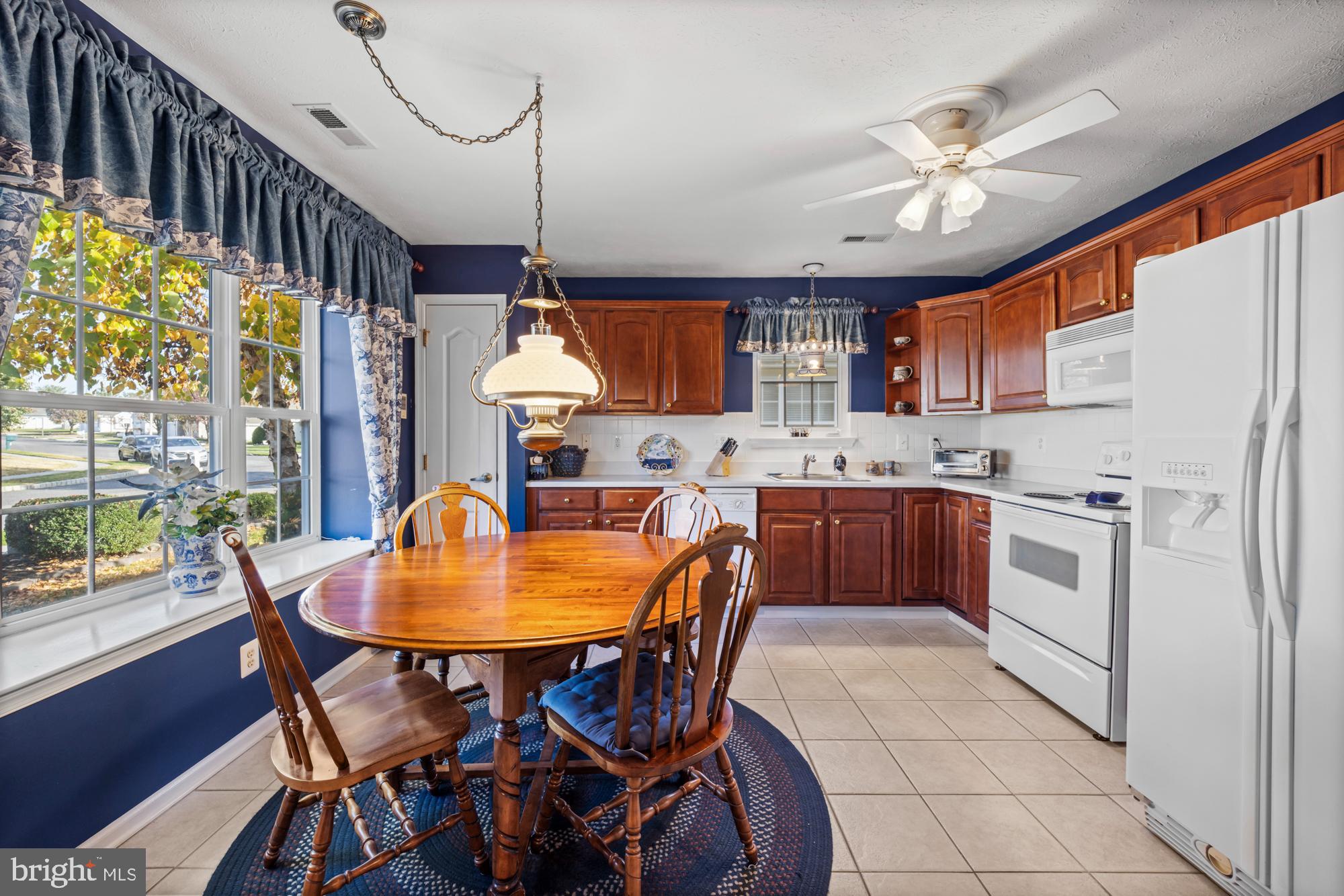 21 Brandon Lane Sewell, NJ 08080 - Photo 3 of 44 a kitchen with a table chairs and a refrigerator