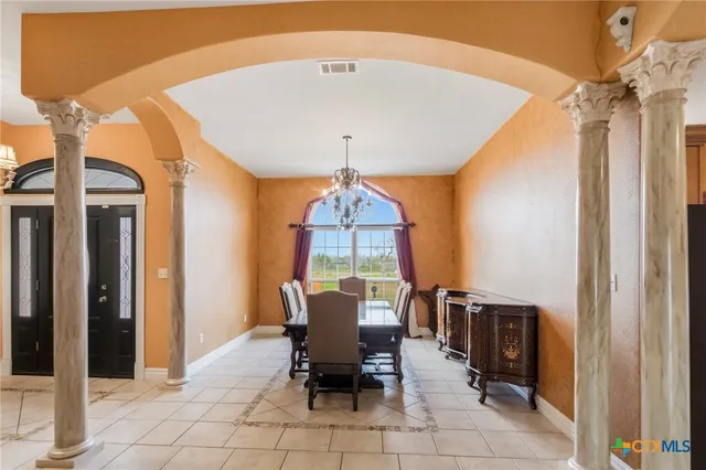 a kitchen with a sink a counter and chairs