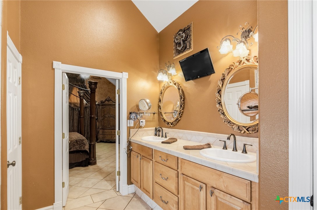 1739 Old Goliad Road Victoria, TX 77905 - Photo 21 of 43 a bathroom with a double vanity sink and a mirror